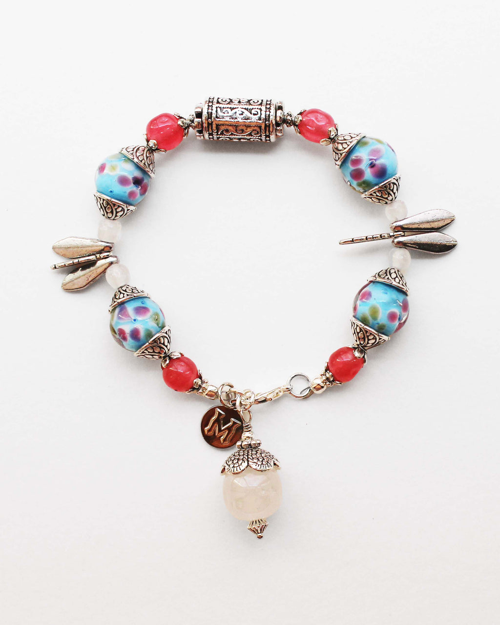 Colorful beaded bracelet with floral designs on a white background