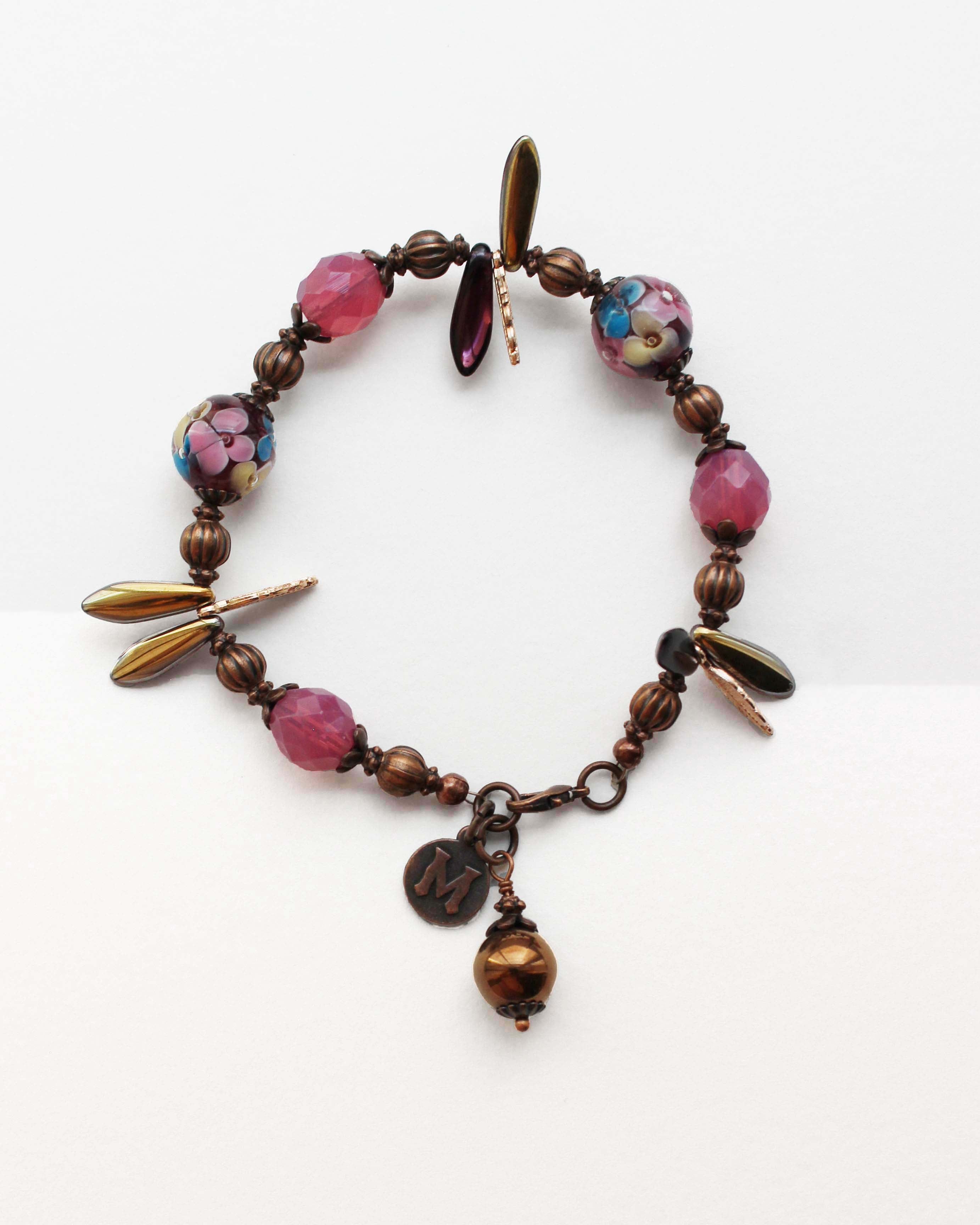 Bracelet with colorful beads and charms on a white background
